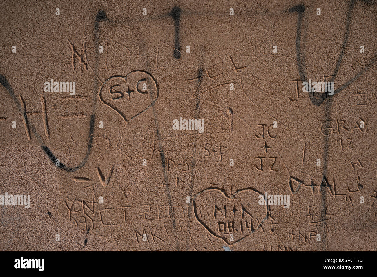 Initials and hearts carved into a wall, Venice, Italy Stock Photo