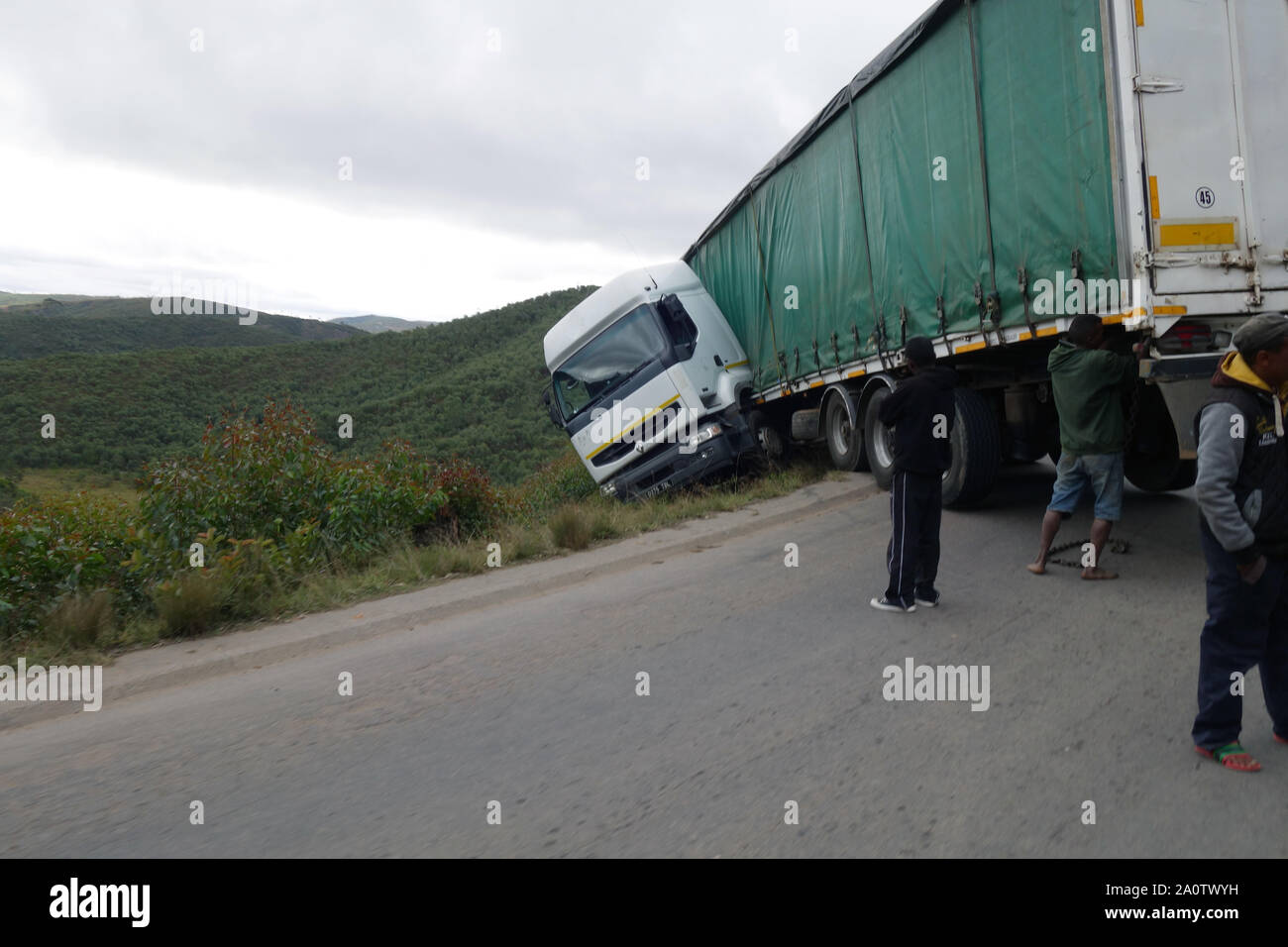 Jacknifed truck hanging over steep mountain slope, RN2 outside Antananarivo, Madagascar. no MR or PR Stock Photo