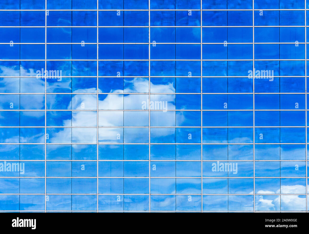 Blue sky and clouds reflected in modern office building windows Stock ...