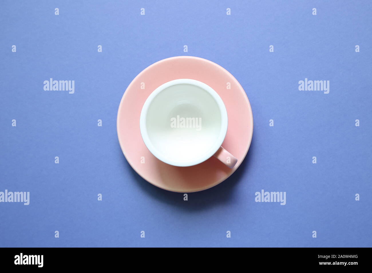 Pink coffee cup on purple background Stock Photo