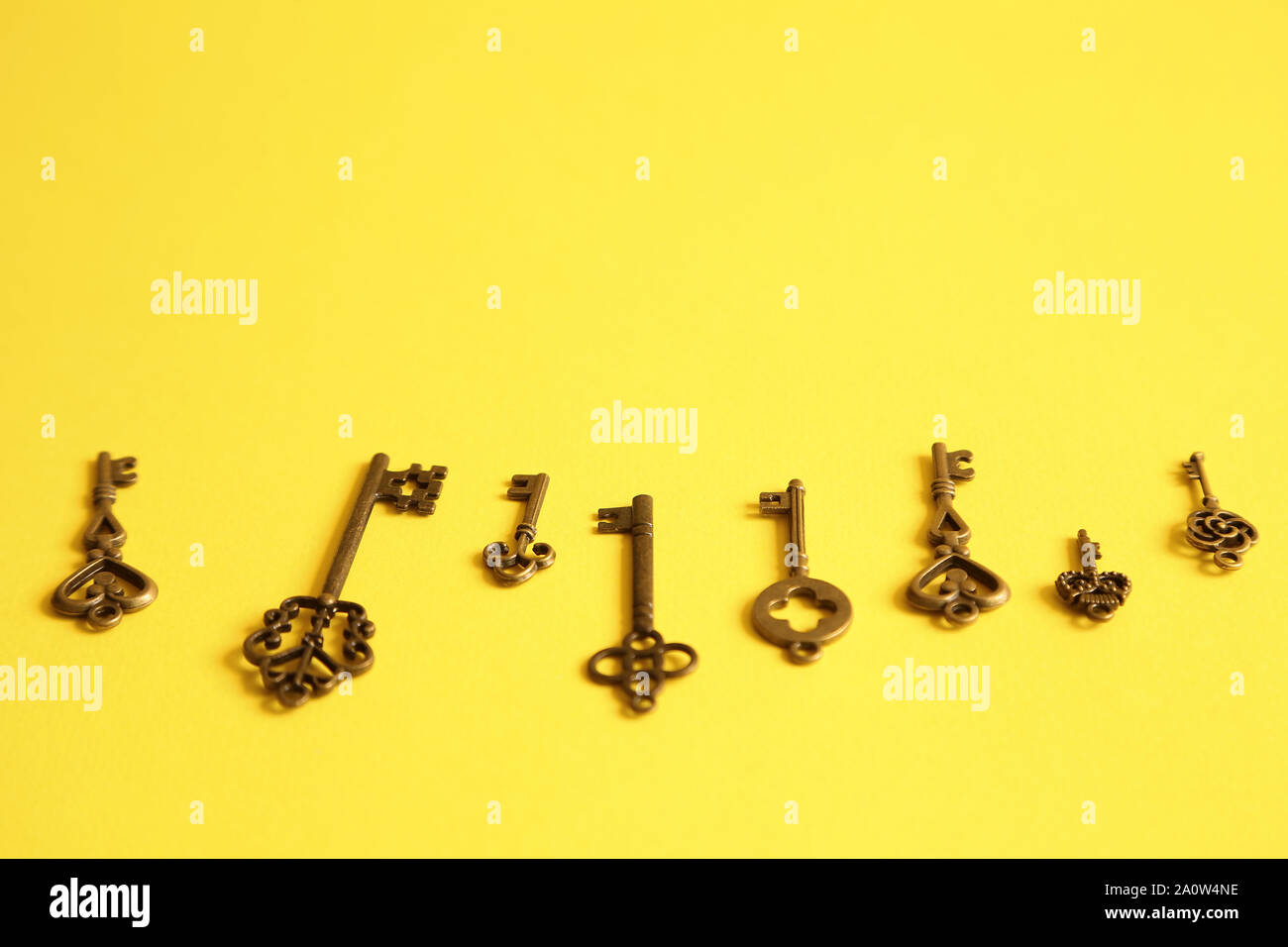 Different keys on yellow background. Choice and right solution concept Stock Photo