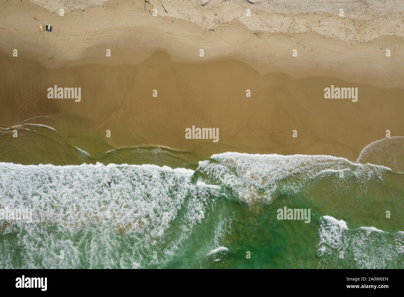 Straight down shot of beautiful beach with waves breaking on shore line Stock Photo