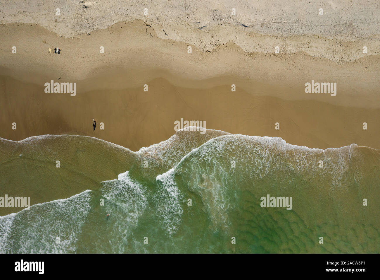 Straight down shot of beautiful beach with waves breaking on shore line Stock Photo
