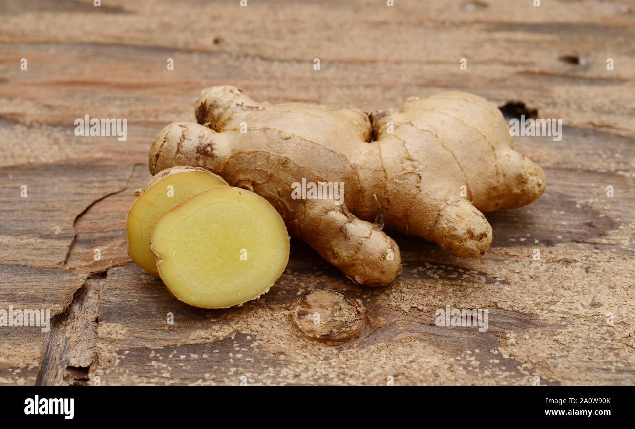 Raw ginger on a wooden background Stock Photo