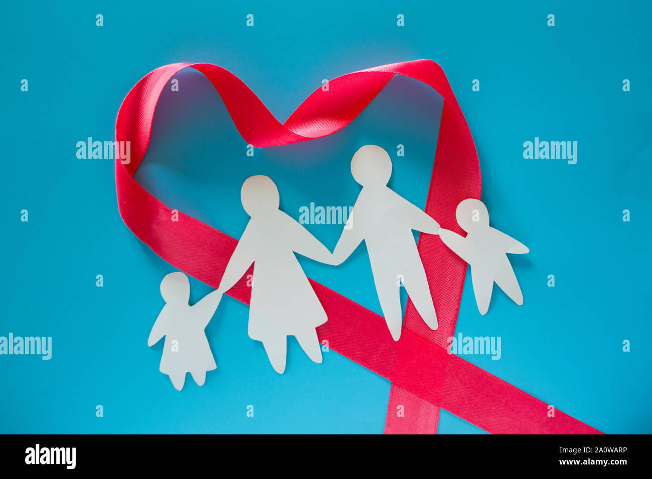 Paper family on blue background with copy space Stock Photo - Alamy