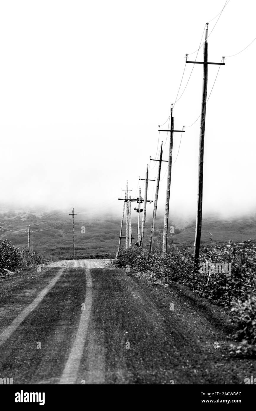 Wooden power lines near country road in the Kamchatka mountains. Russia