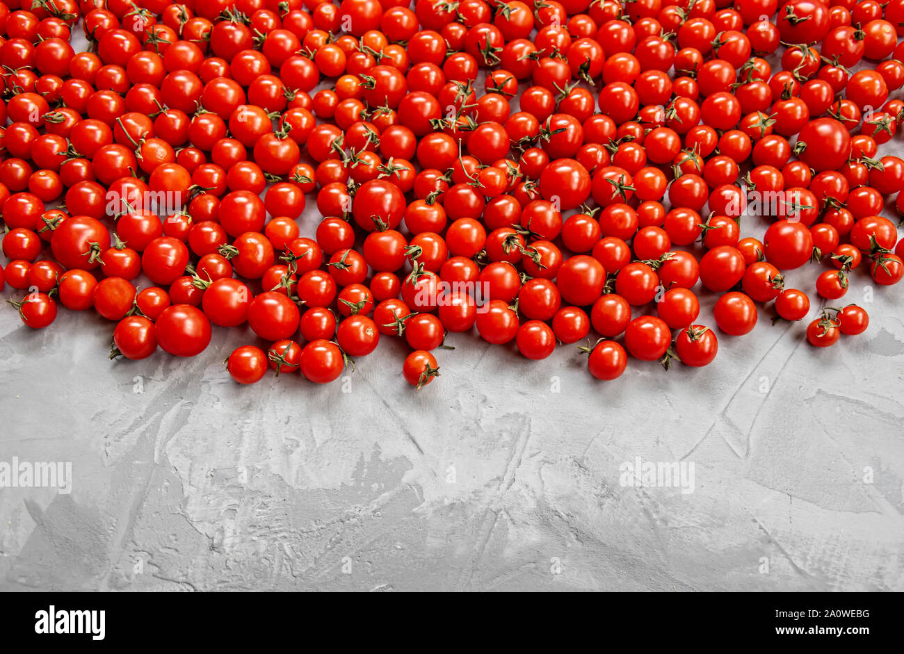 Cherry tomato pattern on a gray background. top view. Copy space. Stock Photo