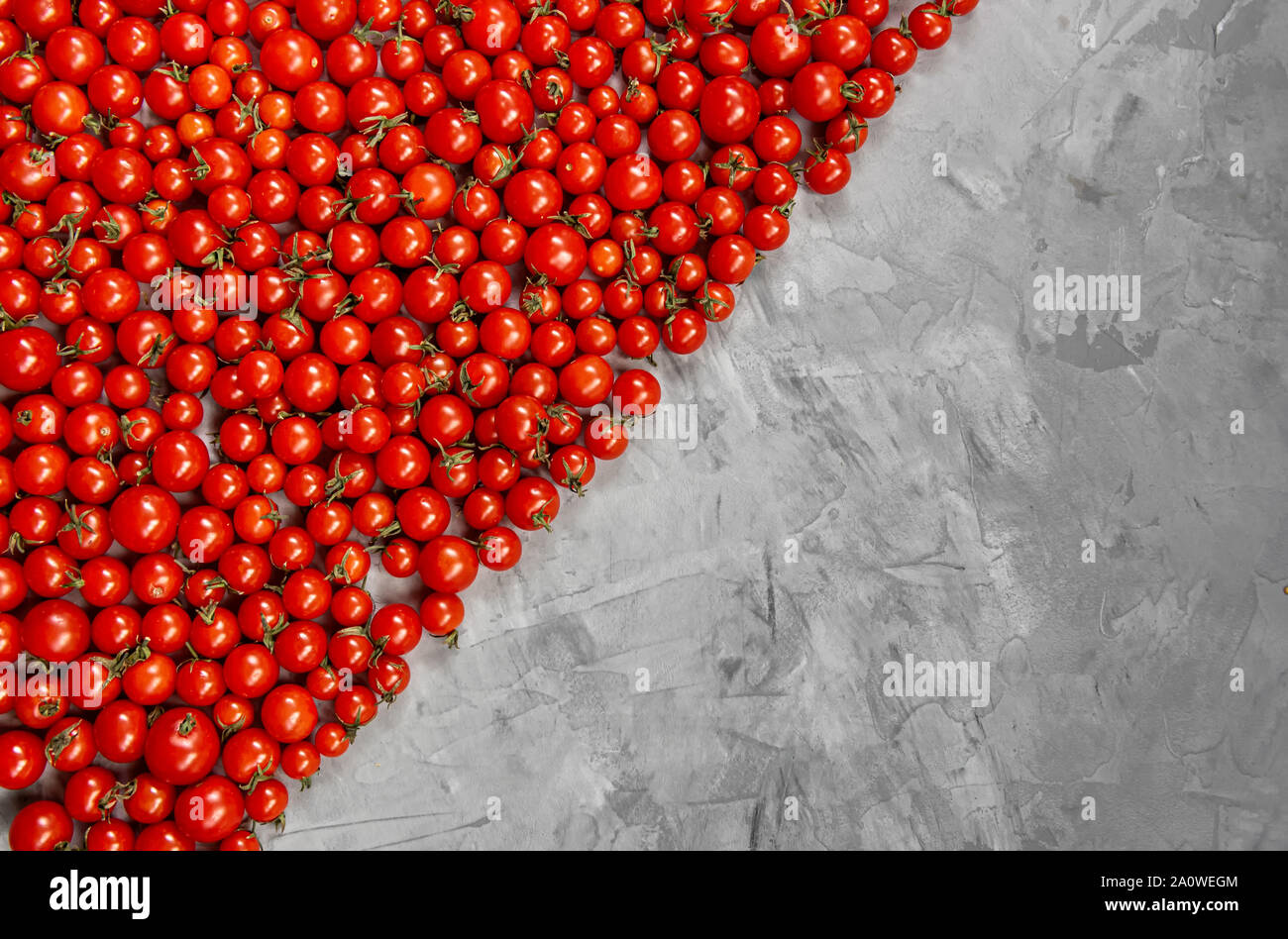 Cherry tomato pattern on a gray background. Flat lay, top view. Stock Photo