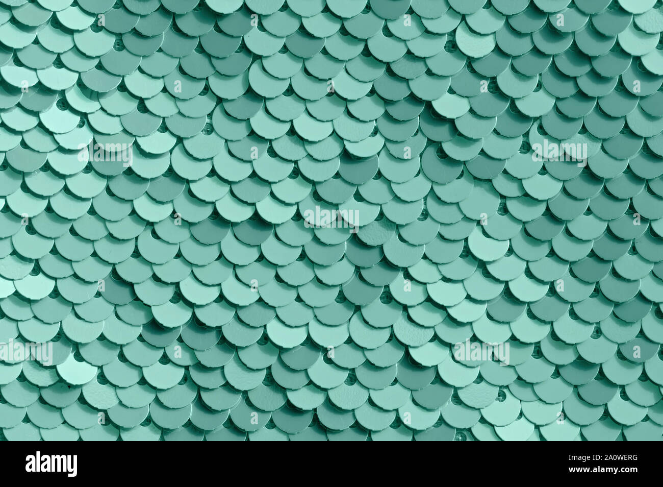 Abstract background of colored sequins. Color neo mint. Close up. Stock Photo