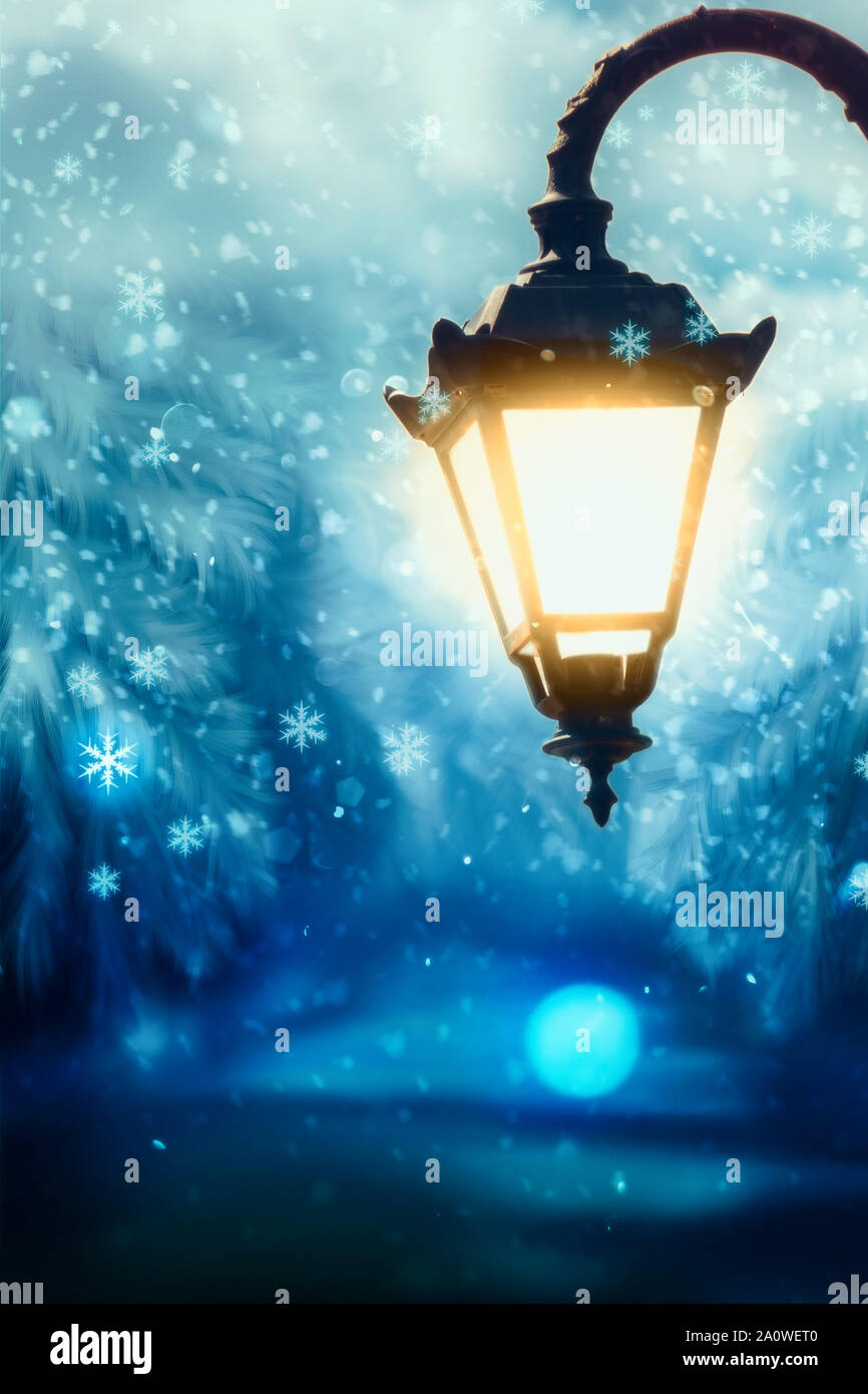 Lit up street lamp at snowy winter night close up, photo manipulation Stock  Photo - Alamy