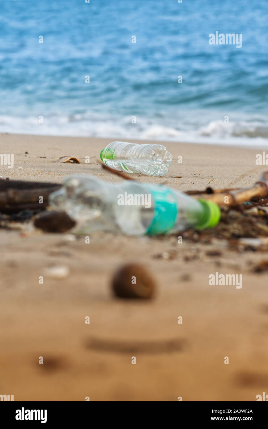 Plastic bottle waste on the beach. Single use plastic botlle being dumped on the beach polluting beach environment and marine life Stock Photo