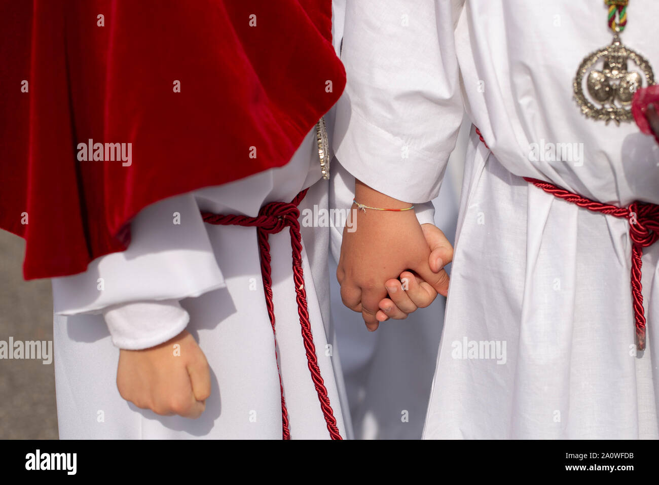 Interlaced hands in a procession, Holy Week Stock Photo