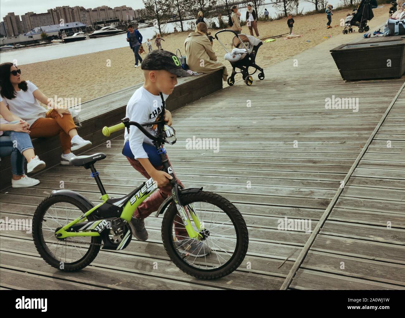 St. Petersburg, Russia-01.09.2019: a child rides a Bicycle on the Playground. Young cyclist on a Sunny day. Stock Photo