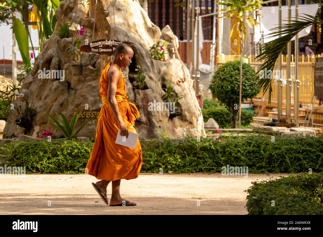 Siem Reap / Cambodia - October 26 2018: Monk walking through Wat Damnak garden in Siem Reap Cambodia Stock Photo