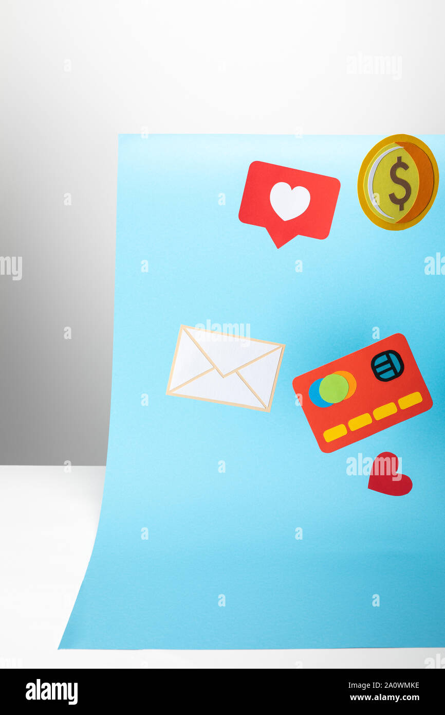 colorful paper icons on blue background, finance concept Stock Photo
