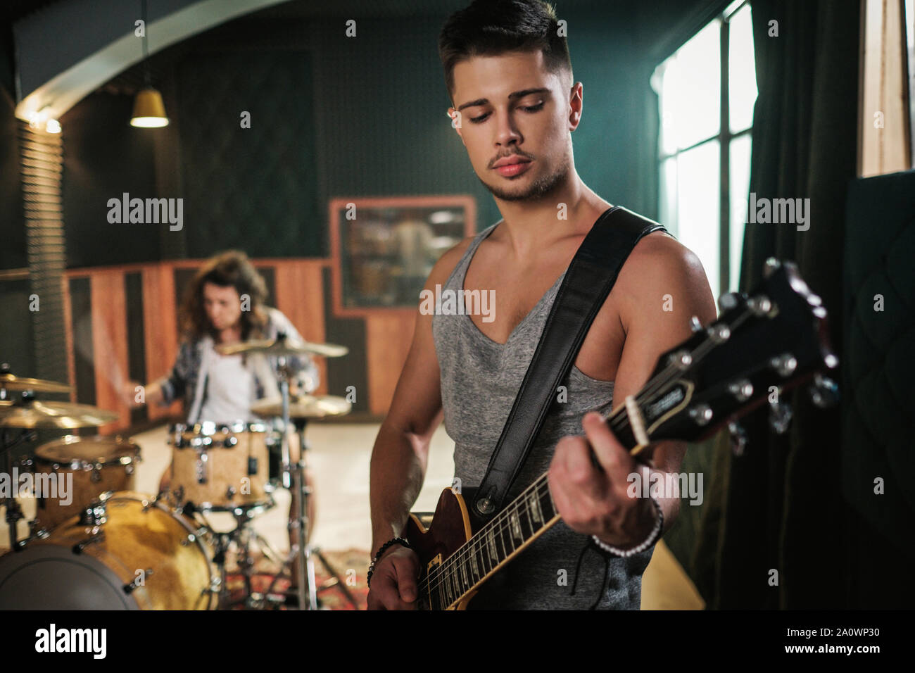 Music band having rehearsal in a studio Stock Photo - Alamy