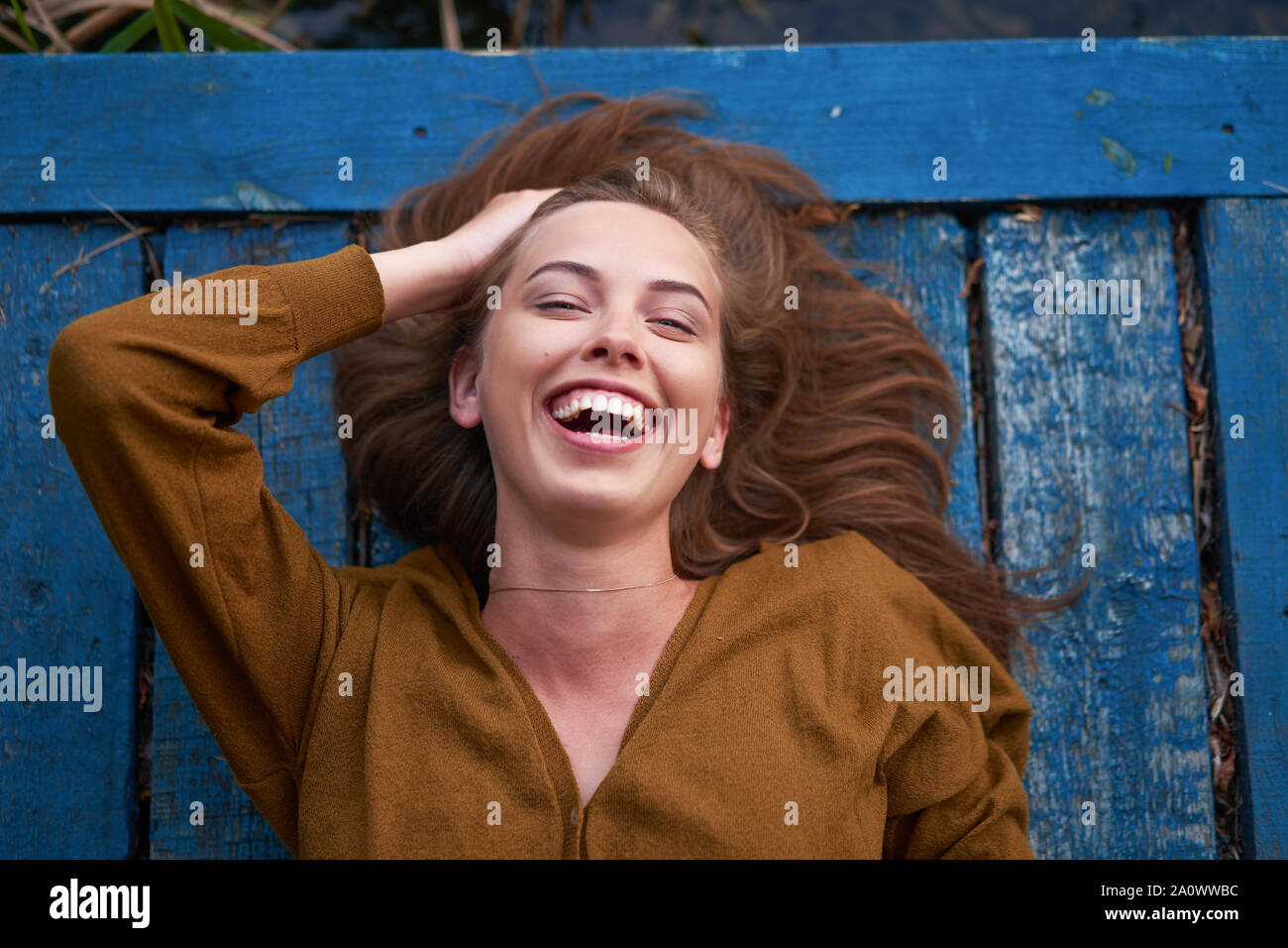Beautiful Caucasian Young Woman Lying On Her Back On Wooden