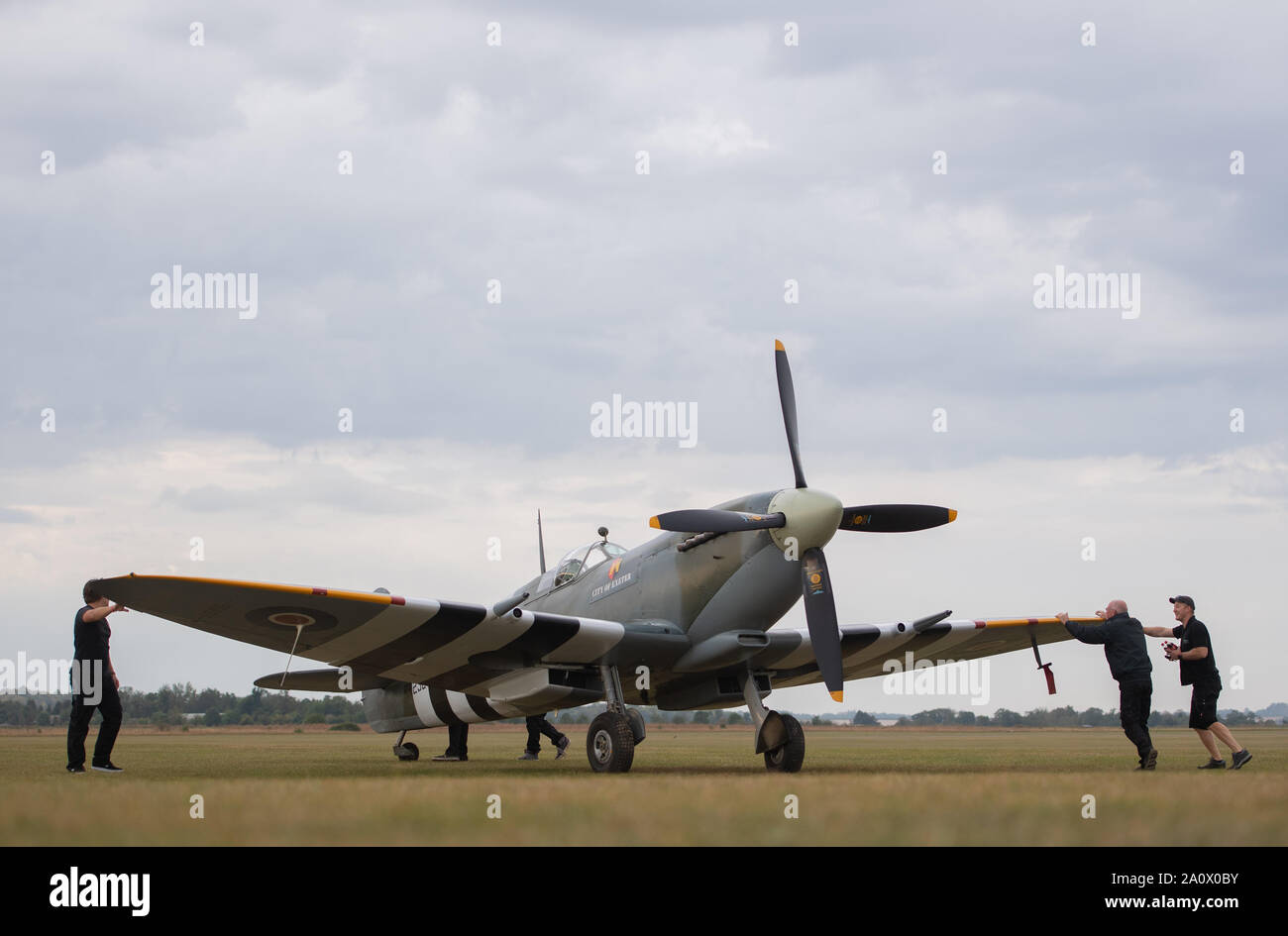 A Supermarine Spitfire is manoeuvred onto the flightline during the Duxford Battle of Britain Air Show at the Imperial War Museum in Duxford, Cambridgeshire. Stock Photo