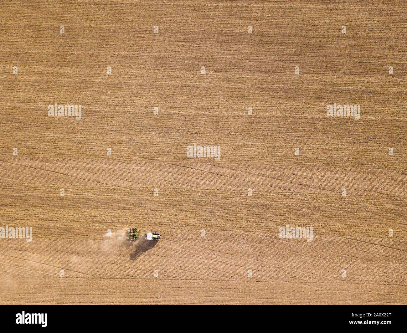 Tractor ploughing / global warning - bone dry field Stock Photo