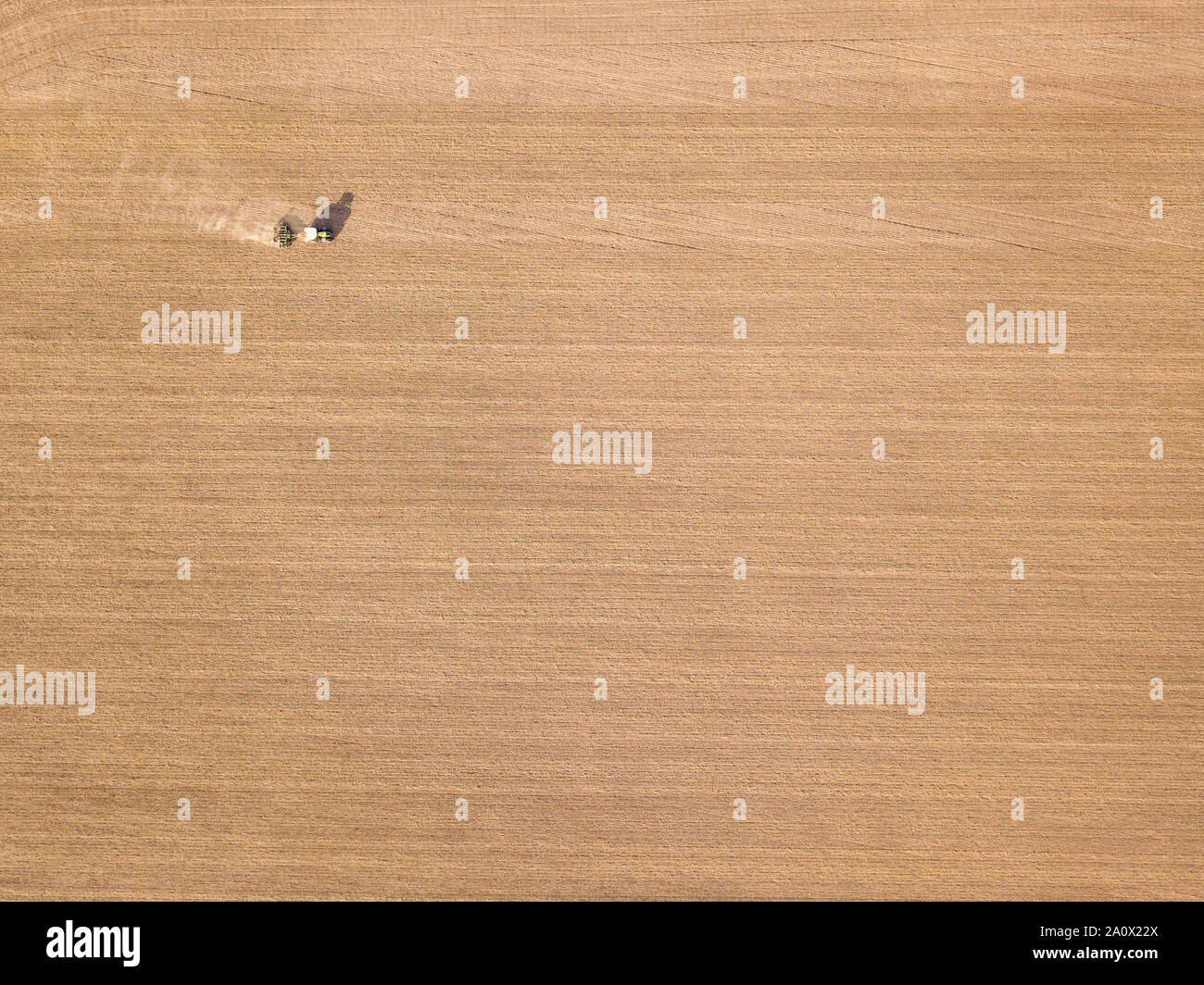 Tractor ploughing / global warning - bone dry field Stock Photo