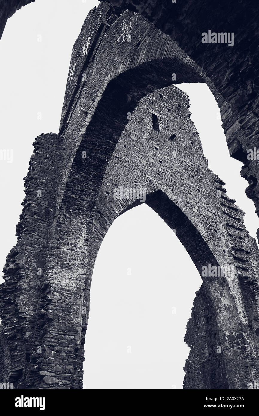 Black and white image focused on the arches of the ruins at Talley Abbey in Carmarthenshire. Wales Stock Photo