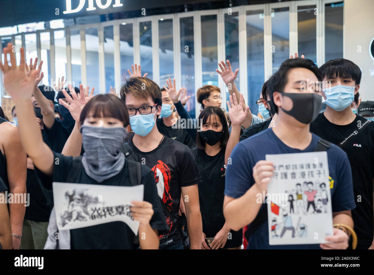 Pro-democracy protesters sing songs and shout slogans as they gather in a shopping mall during a rally in Yeun Long.Pro-democracy protesters have continued demonstrations across Hong Kong, calling for the city's Chief Executive Carrie Lam to immediately meet the rest of their demands, including an independent inquiry into police brutality, the retraction of the word “riot” to describe the rallies, and genuine universal suffrage, as the territory faces a leadership crisis. Stock Photo