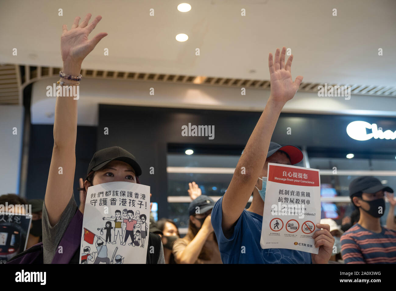 Pro-democracy protesters holding placards while singing songs and shouting slogans as they gather in a shopping mall during a rally in Yeun Long.Pro-democracy protesters have continued demonstrations across Hong Kong, calling for the city's Chief Executive Carrie Lam to immediately meet the rest of their demands, including an independent inquiry into police brutality, the retraction of the word “riot” to describe the rallies, and genuine universal suffrage, as the territory faces a leadership crisis. Stock Photo
