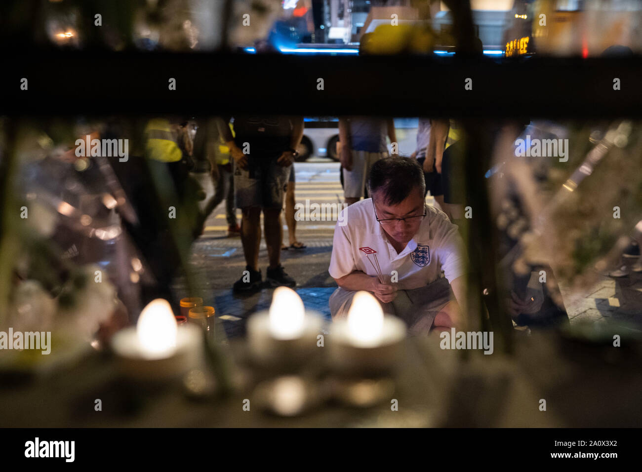A man lights a candle to pay tribute to those who lost their lives in Prince Edward station on 31st August.Pro-democracy protesters have continued demonstrations across Hong Kong, calling for the city's Chief Executive Carrie Lam to immediately meet the rest of their demands, including an independent inquiry into police brutality, the retraction of the word “riot” to describe the rallies, and genuine universal suffrage, as the territory faces a leadership crisis. Stock Photo