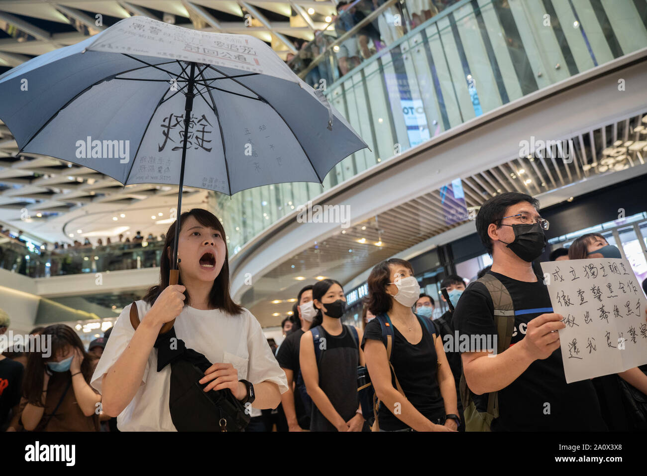 Pro-democracy protesters sing songs and shout slogans as they gather in a shopping mall during a rally in Yeun Long. Pro-democracy protesters have continued demonstrations across Hong Kong, calling for the city's Chief Executive Carrie Lam to immediately meet the rest of their demands, including an independent inquiry into police brutality, the retraction of the word “riot” to describe the rallies, and genuine universal suffrage, as the territory faces a leadership crisis. Stock Photo