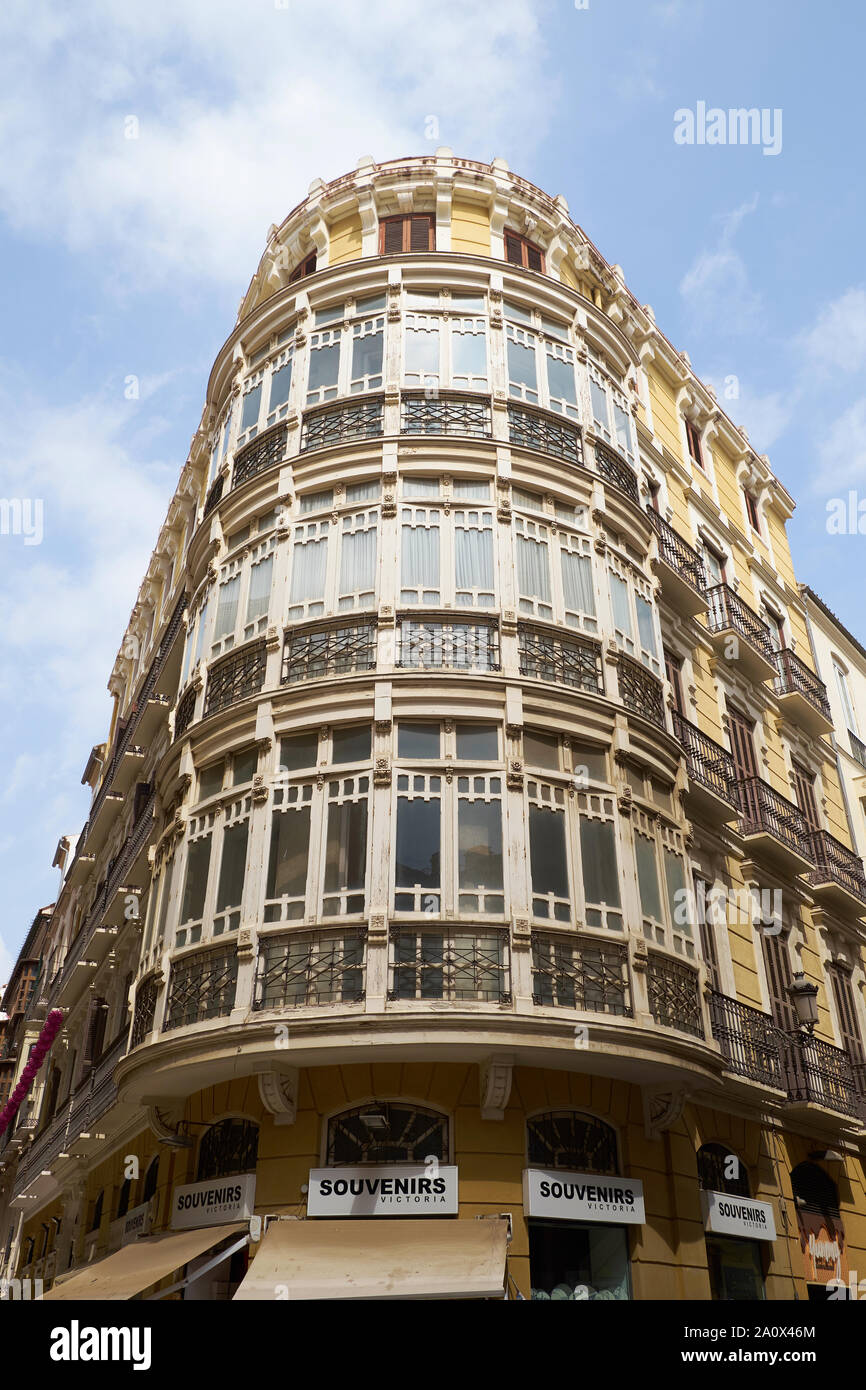 Building with rounded corner. Typical example of architecture in the
