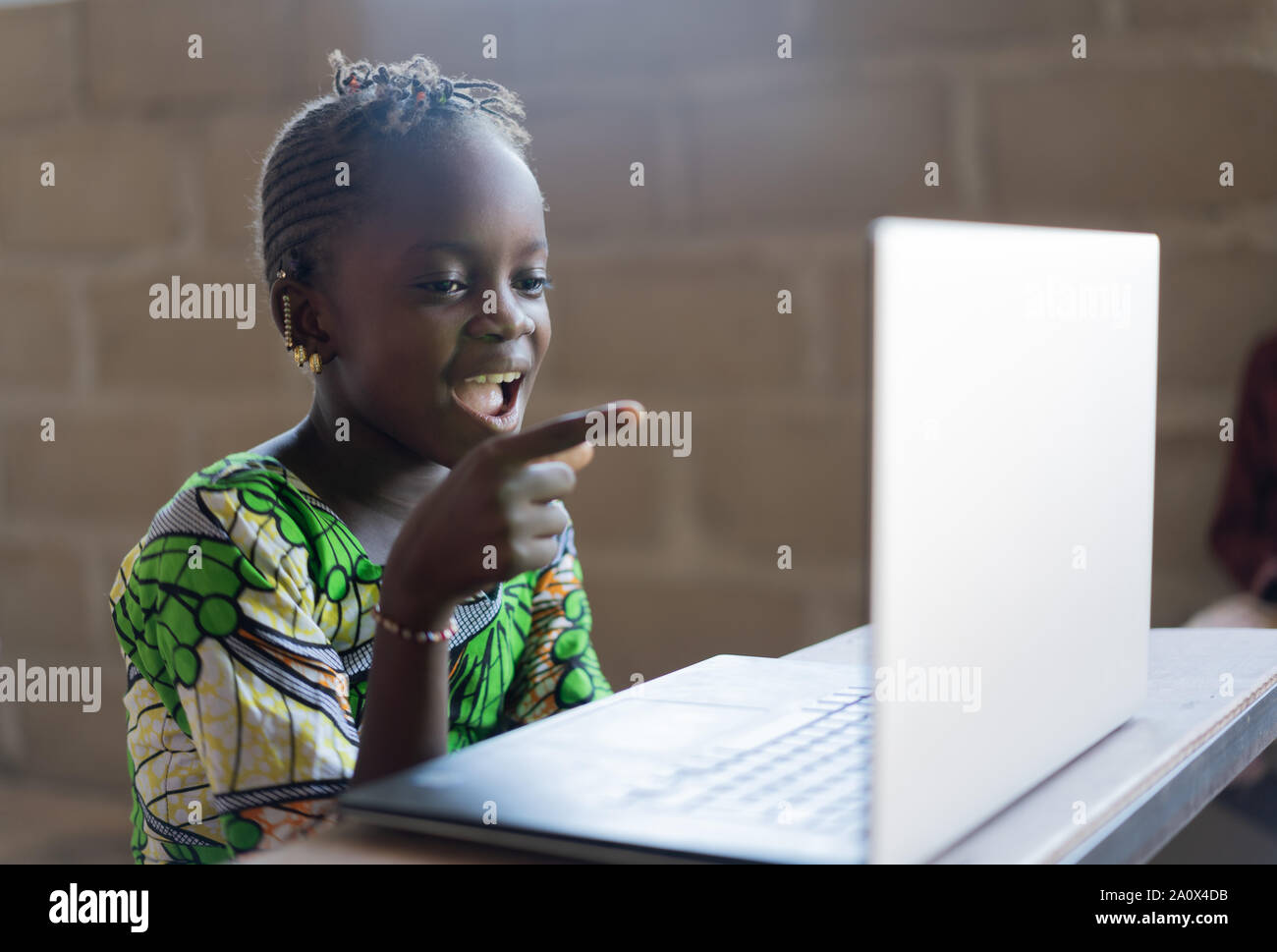 Curious preschool african mixed race girl using laptop on couch, little  smart black kid typing on computer chatting with friends online alone at  home, child security, children and gadget concept Stock Photo