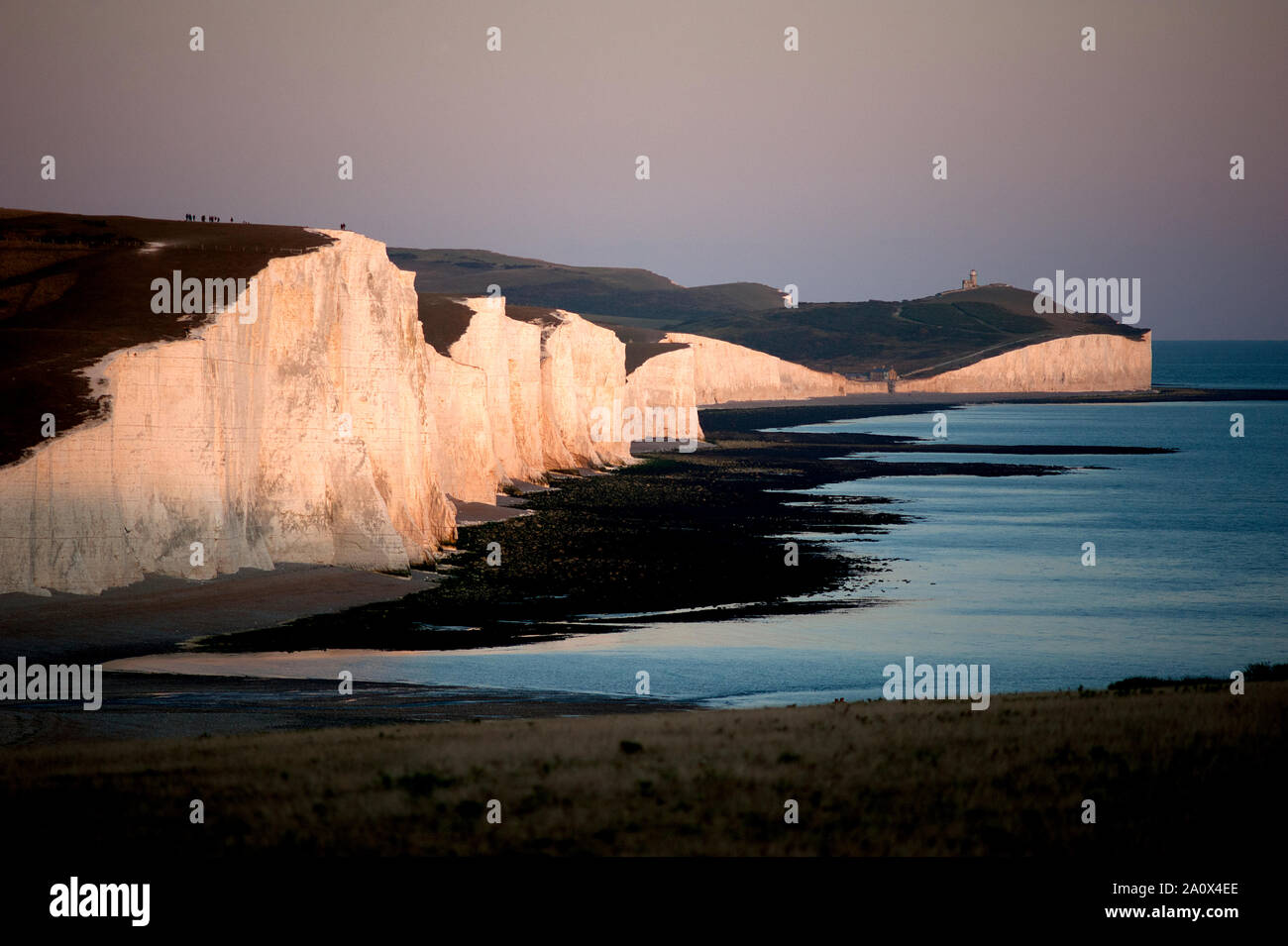 A dramatic view of the Seven Sisters at sunset. The Seven Sisters are a series of white chalk cliffs in Sussex by the English Channel. Stock Photo