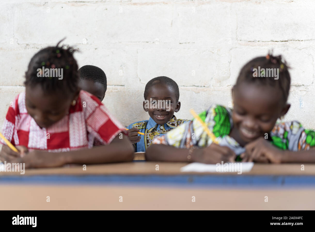 Classroom Full of African Students Smiling and Working in School Stock Photo