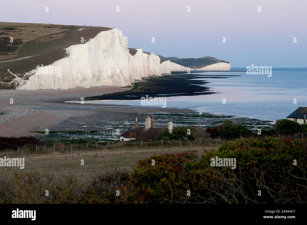 A dramatic view of the Seven Sisters at sunset. The Seven Sisters in Sussex, England are a series of white chalk cliffs by the English Channel. Stock Photo