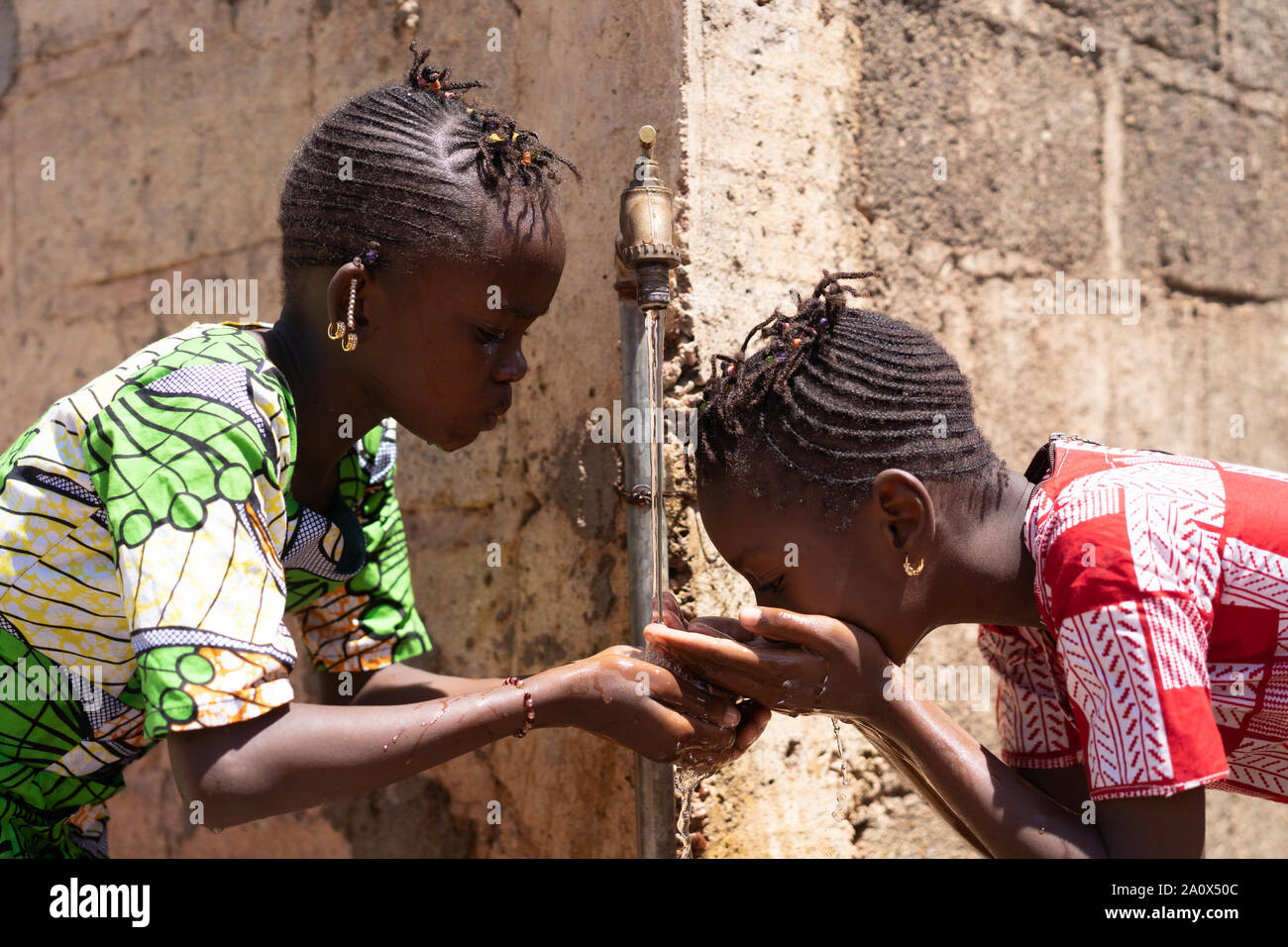 Water Crisis - African Women Finally Getting Fresh Water Stock Photo