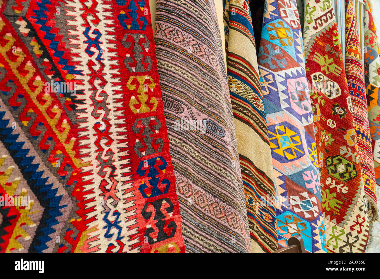 Different traditional turkish carpets hanging on a wall on a street in old town Kaleichi, Antalya, Turkey Stock Photo