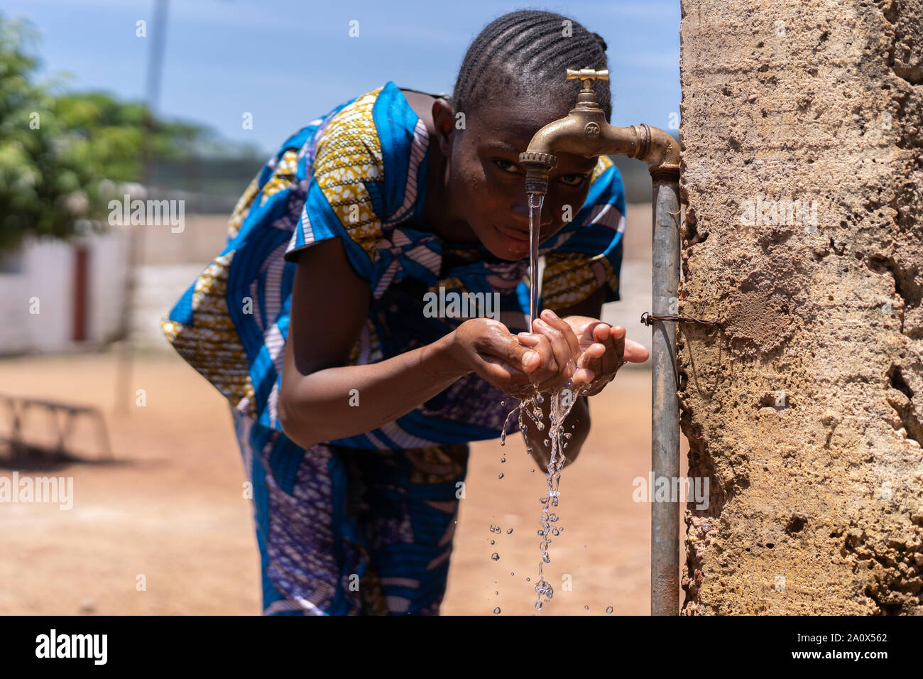 Candid picture of African Black Girl Drinking Water Bamako Mali Stock Photo