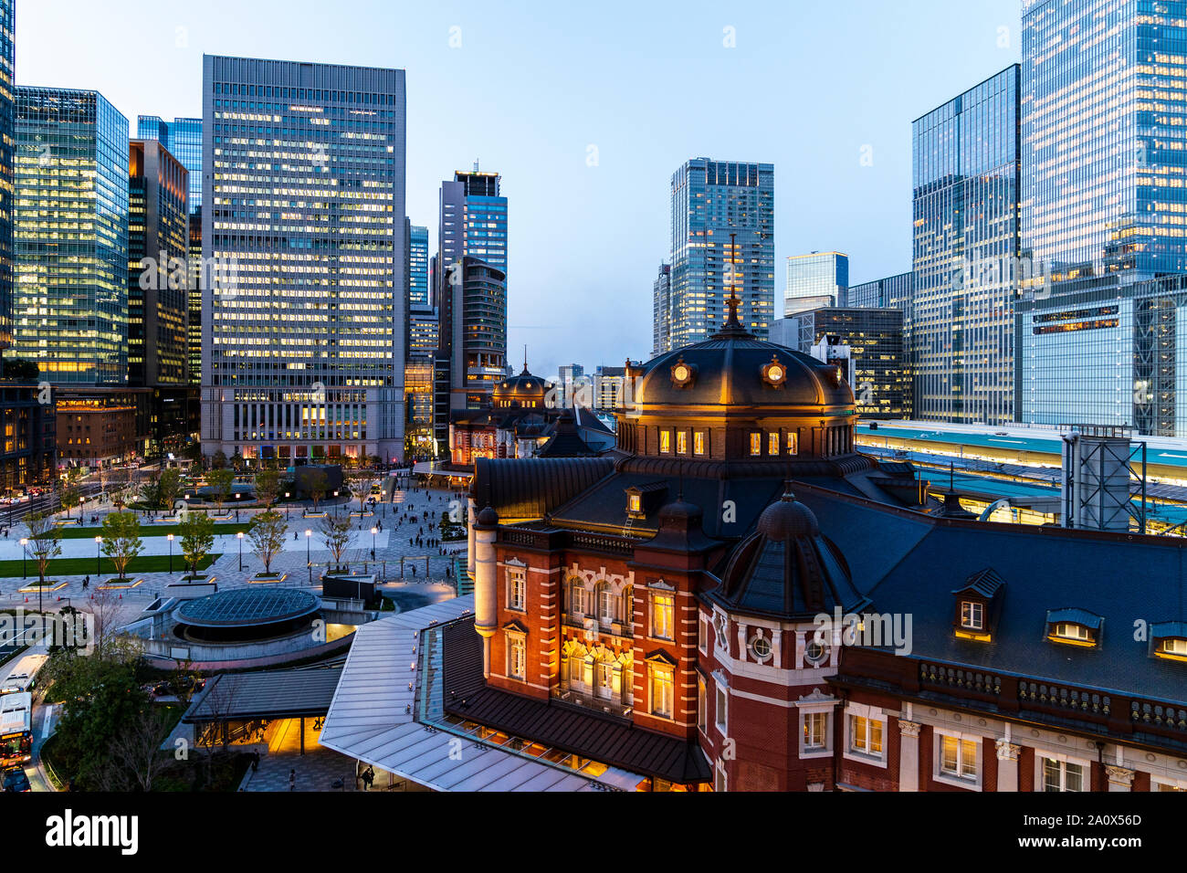Tokyo station with the Nihon Seimei Marunouchi Building and other high rise builldings all illuminated during the blue hour, dusk early evening. Stock Photo