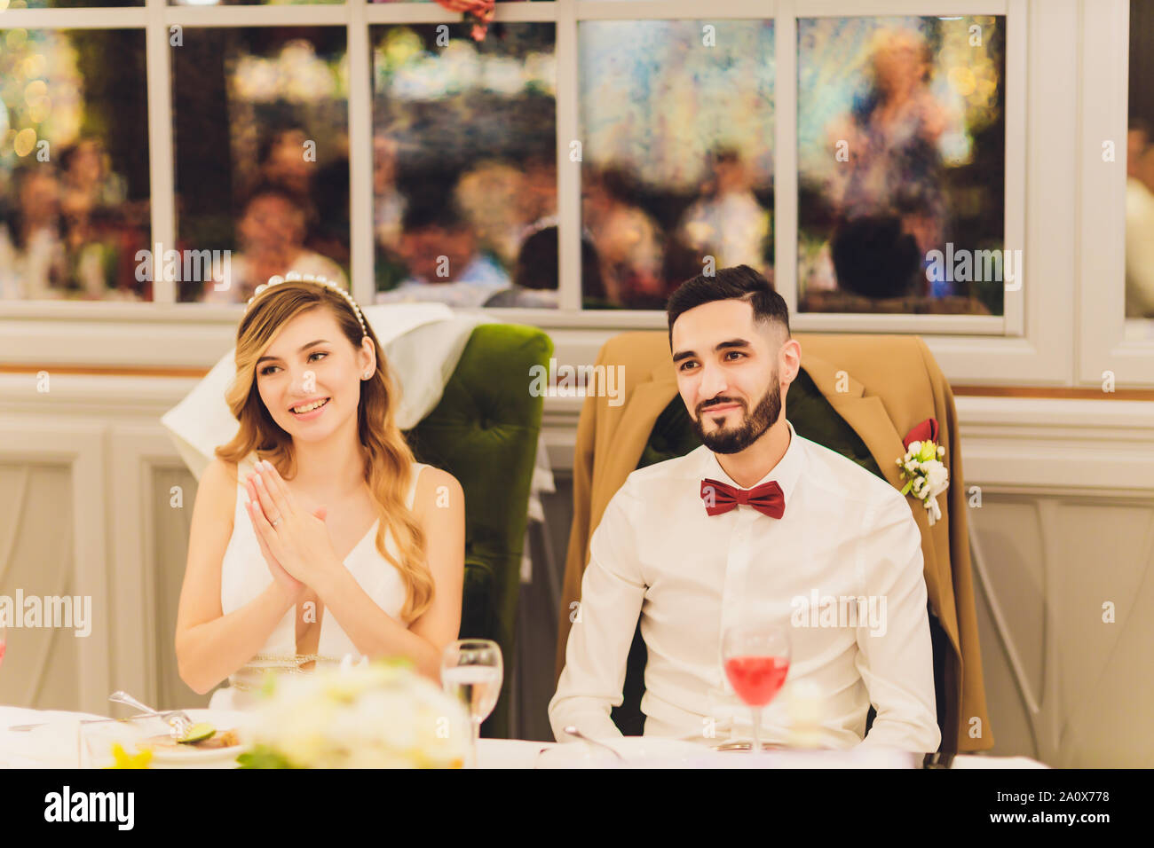 Stylish Bride And Groom Sitting Together At Beautiful Pink