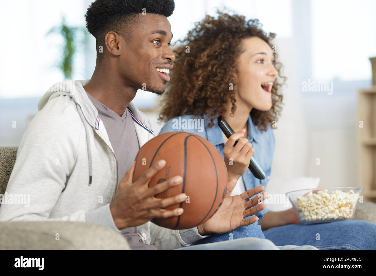 couple watching basket on tv Stock Photo Alamy