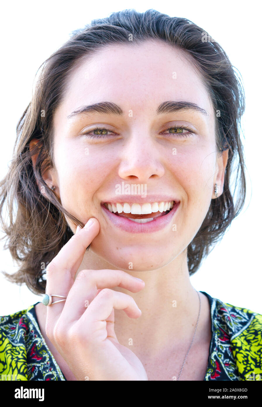 Portrait of peaceful pretty woman smiling and gently touching her face, on white background Stock Photo