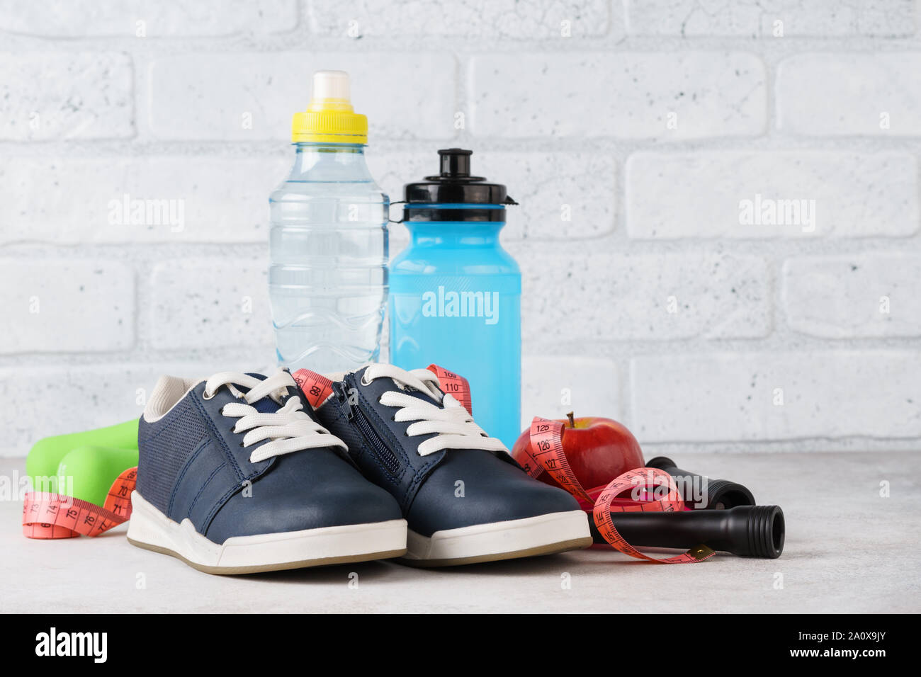 Various fitness equipment on light background. Sporting goods. Health and slimming concept. Stock Photo