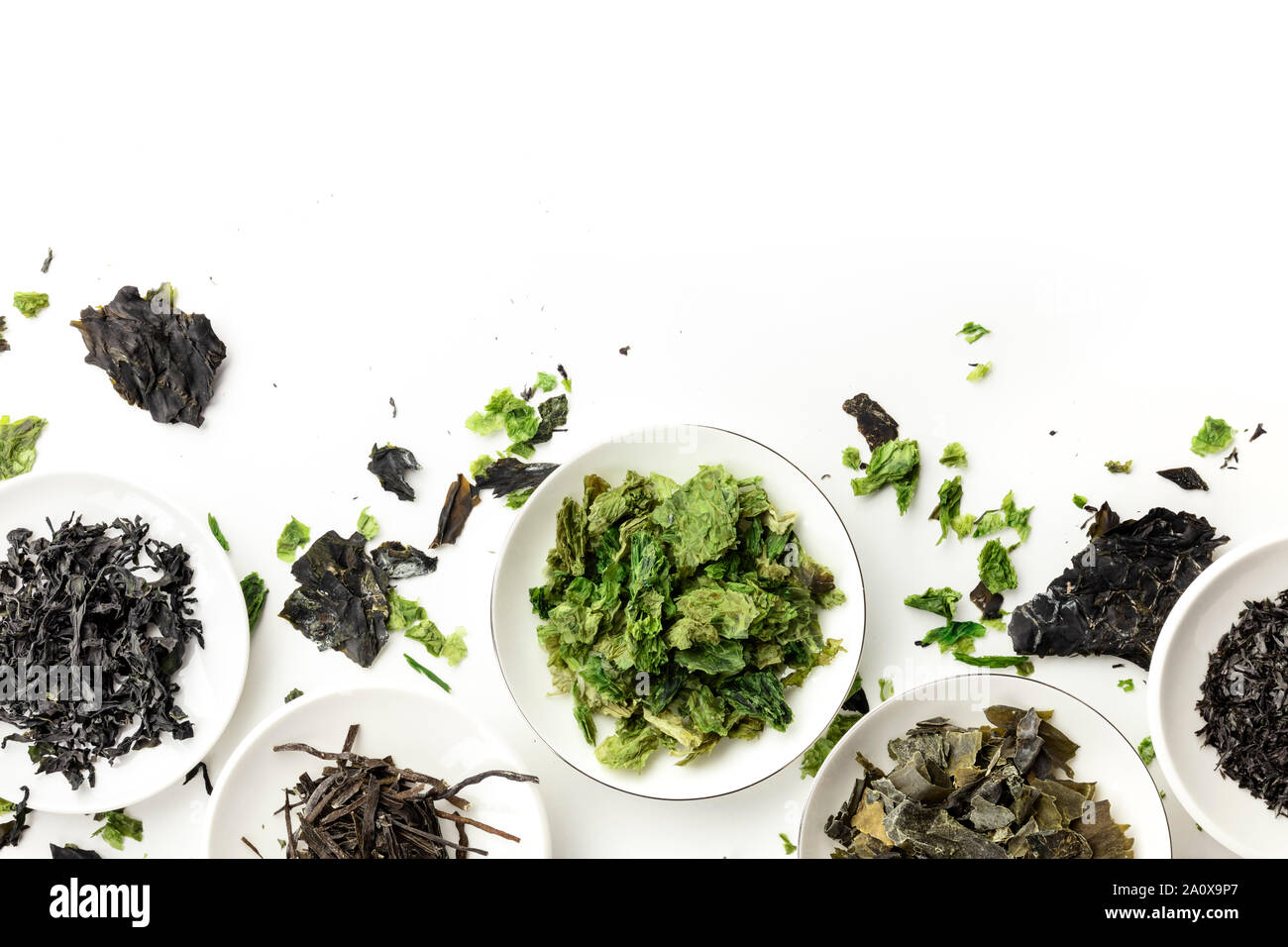 Many dry seaweed, sea vegetables, overhead shot on white. Superfoods background with copyspace Stock Photo