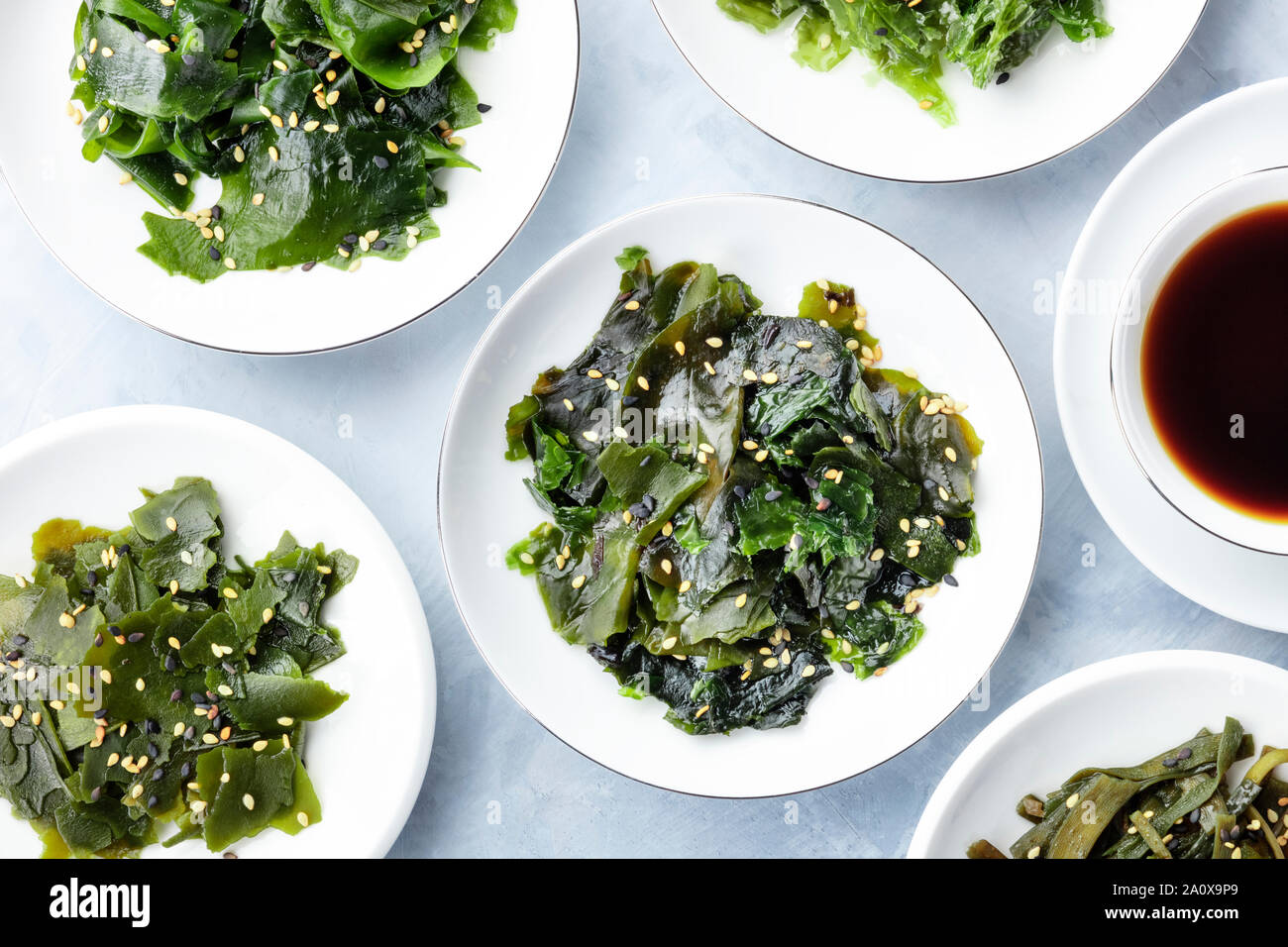 Various cooked seaweed, sea vegetables, shot from the top with a sauce and sesame seeds Stock Photo