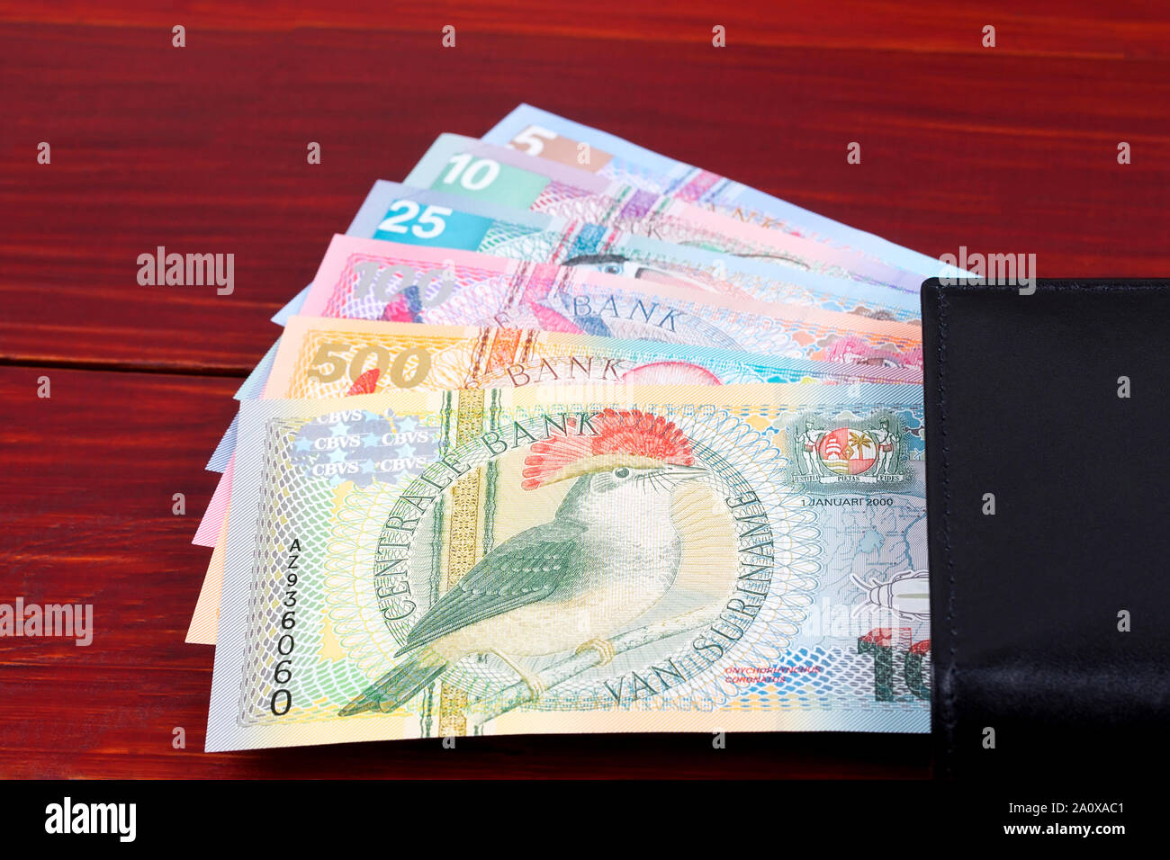 Surinamese guilder in the black wallet Stock Photo