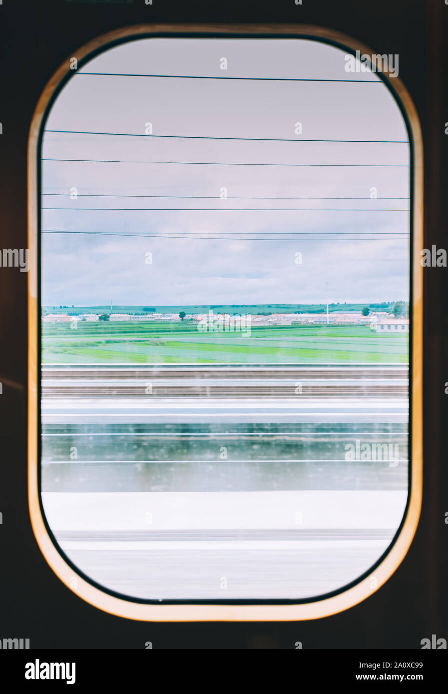 View from high speed train window in motion of countryside and sky Stock Photo