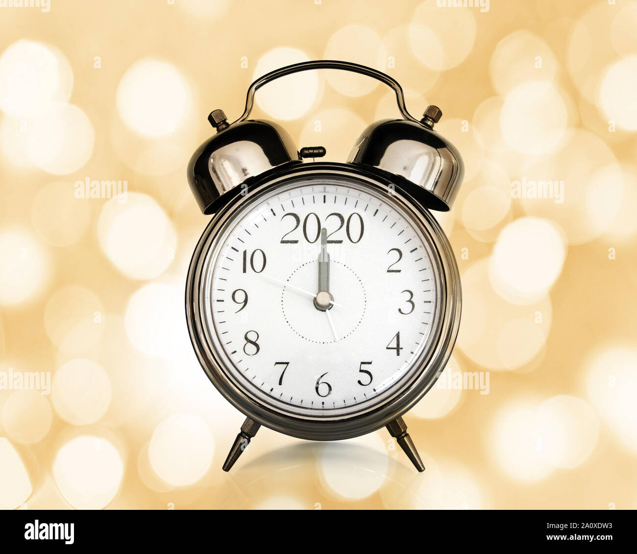 2020 written on a vintage alarm clock, bokeh lights background, happy new year eve party time and midnight countdown celebration concept Stock Photo
