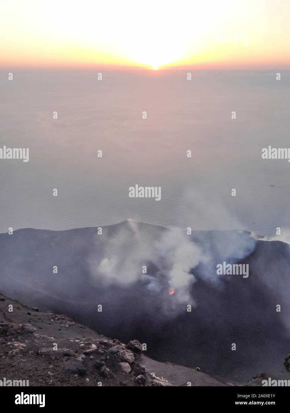 smoky crater scenery at Stromboli volcano near Sicily at evening time Stock Photo