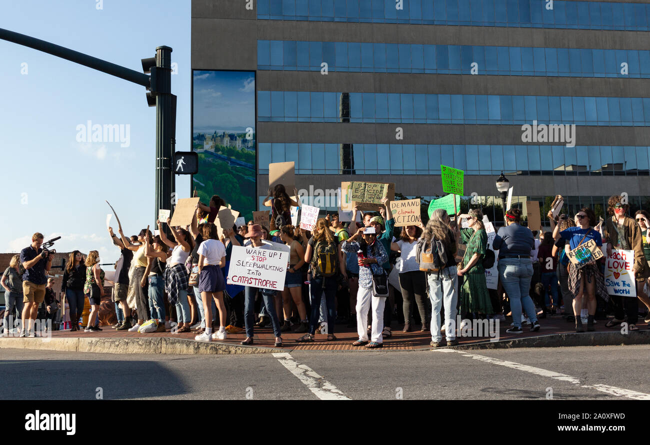 Protesters fill Pack Square, waving signs at passing cars, at the International Climate Justice Rally in Asheville, NC, USA. Stock Photo