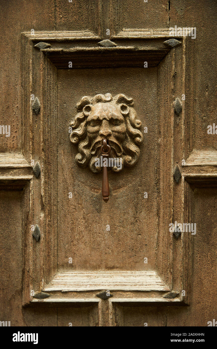 Human face door knocker in a vintage wood door of a house in Saint-Lizier (Saint-Girons, Ariège, Occitanie, Pyrenees, France) Stock Photo